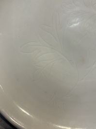 A Chinese Dehua blanc de Chine incised 'Peony' plate, 17/18th C.