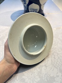 A Chinese blue and white powder-blue-ground 'He Xiangu 何仙姑' vase and cover, 19th C.