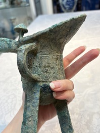 A Chinese archaic bronze wine vessel with Taotie design, Jue 爵, late Shang