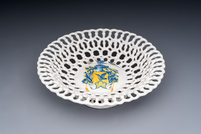 A polychrome Italian maiolica armorial reticulated basket, workshop of Virgiliotto Calamelli, Faenza, 16th C.