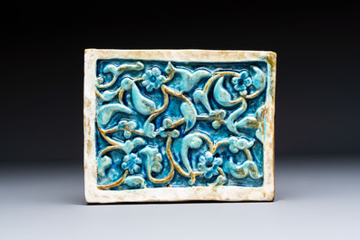 A Timurid polychrome-glazed rectangular tile with foliage design, on a later metal stand, Central Asia, 14th C.