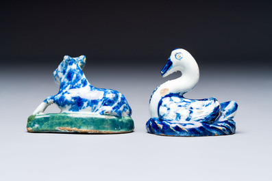 Two polychrome Dutch Delft miniature models of animals, a 'Pineapple' stand and a pair of blue and white plates, 18th C.