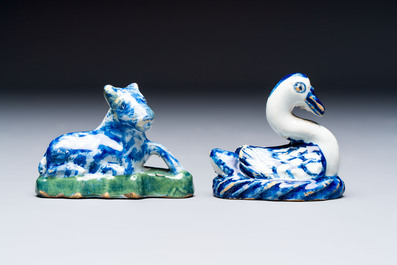 Two polychrome Dutch Delft miniature models of animals, a 'Pineapple' stand and a pair of blue and white plates, 18th C.