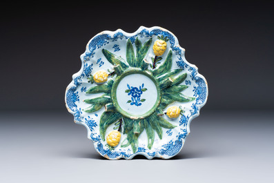 Two polychrome Dutch Delft miniature models of animals, a 'Pineapple' stand and a pair of blue and white plates, 18th C.