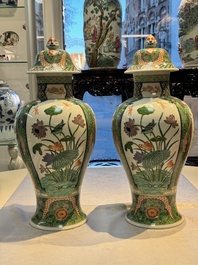 A pair of famille verte-style 'Lotus Pond and Flower Basket' vases and covers, Samson, Paris, 19th C.