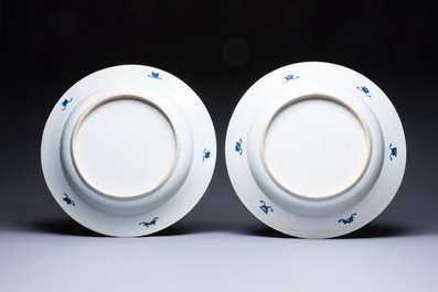 A pair of large Chinese blue and white 'Peacock Border' chargers with floral design, Kangxi