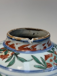 A Chinese wucai &lsquo;Buddhist Lion&rsquo; vase and cover, Transitional period