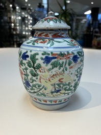 A Chinese wucai &lsquo;Buddhist Lion&rsquo; vase and cover, Transitional period