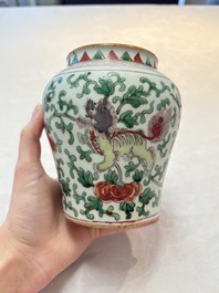A small Chinese wucai 'Buddhist Lions and Peony Scrolls' jar, Transitional period