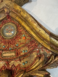 An Italian carved wood and coral- and turquoise-decorated reliquary containing a relic ex cineribus of Saint Teresa of Jesus, early 20th C.