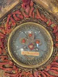 An Italian carved wood and coral- and turquoise-decorated reliquary containing a relic ex cineribus of Saint Teresa of Jesus, early 20th C.