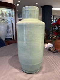 A Chinese celadon-glazed rouleau vase with incised floral design, 18th C.