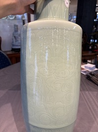 A Chinese celadon-glazed rouleau vase with incised floral design, 18th C.
