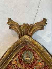An Italian carved wood and coral- and turquoise-decorated reliquary containing a relic ex cineribus of Saint Teresa of Jesus, early 20th C.