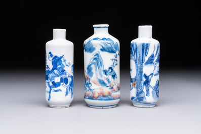 Three Chinese blue, white and copper-red snuff bottles with narrative design, 19th C.