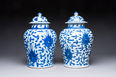Two Chinese blue and white 'Lotus Scroll' vases and covers, Kangxi