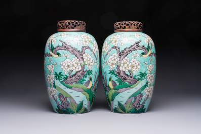 A pair of fine Chinese famille verte turquoise-ground 'Magpie and Prunus' jars with reticulated wooden covers, 19th C.