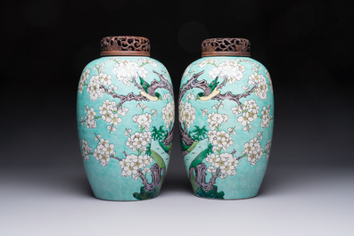 A pair of fine Chinese famille verte turquoise-ground 'Magpie and Prunus' jars with reticulated wooden covers, 19th C.