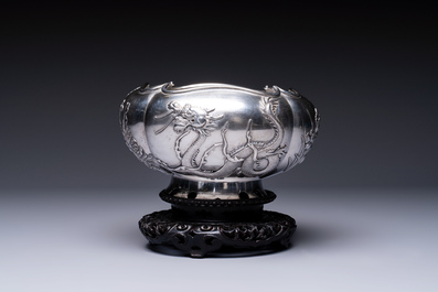 A fine Chinese silver bowl with relief dragon design on reticulated wooden stand, Tai Chang Long 泰昌隆 mark, 19th C.