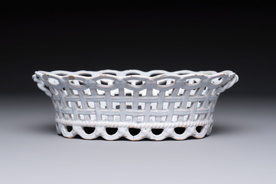 A rare white-glazed Brussels faience reticulated basket on stand, 18th C.