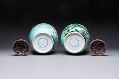 A pair of fine Chinese famille verte turquoise-ground 'Magpie and Prunus' jars with reticulated wooden covers, 19th C.