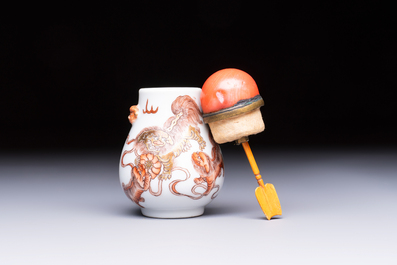 A Chinese gilt-decorated iron-red 'Buddhist Lions' snuff bottle with a red coral stopper, Buddhist Lion mark, Republic
