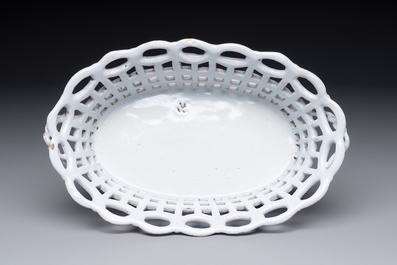 A rare white-glazed Brussels faience reticulated basket on stand, 18th C.