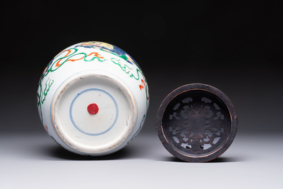 A fine Chinese famille verte 'Buddhist Lions' jar and a reticulated wooden cover, 19th C.