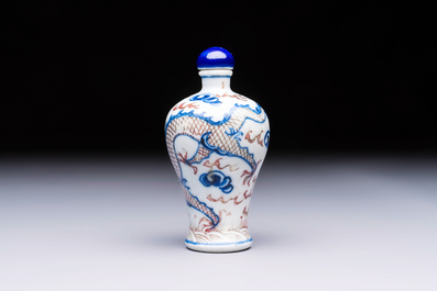 A Chinese blue, white and copper-red 'Dragon' snuff bottle, 19th C.