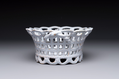 A rare white-glazed Brussels faience reticulated basket on stand, 18th C.