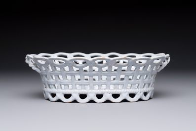 A rare white-glazed Brussels faience reticulated basket on stand, 18th C.