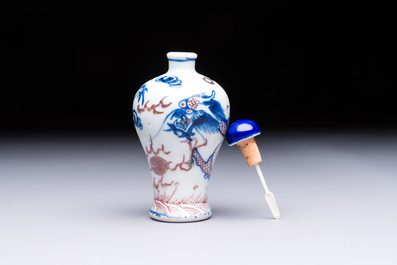 A Chinese blue, white and copper-red 'Dragon' snuff bottle, 19th C.