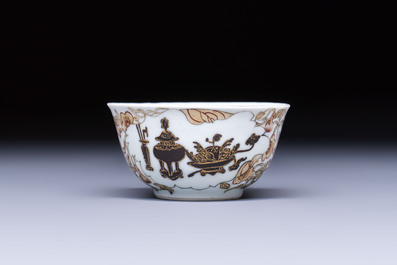 A Chinese gilt-decorated black-enamelled 'Antiquities' cup, Yongzheng/Qianlong