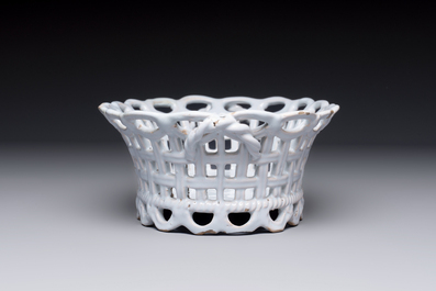 A rare white-glazed Brussels faience reticulated basket on stand, 18th C.