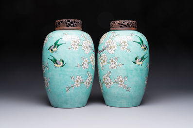 A pair of fine Chinese famille verte turquoise-ground 'Magpie and Prunus' jars with reticulated wooden covers, 19th C.