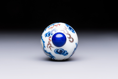 A Chinese blue, white and copper-red 'Dragon' snuff bottle, 19th C.