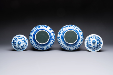 Two Chinese blue and white 'Lotus Scroll' vases and covers, Kangxi