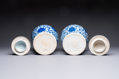 Two Chinese blue and white 'Lotus Scroll' vases and covers, Kangxi