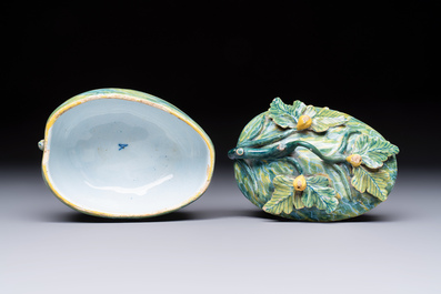 A polychrome Dutch Delft melon-shaped tureen and cover on leaf-shaped stand, 18th C.
