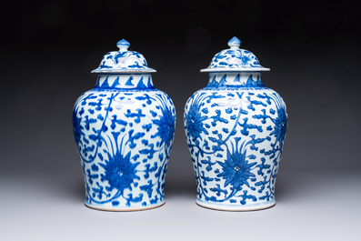 Two Chinese blue and white 'Lotus Scroll' vases and covers, Kangxi