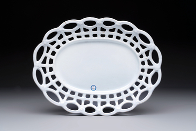 A rare white-glazed Brussels faience reticulated basket on stand, 18th C.
