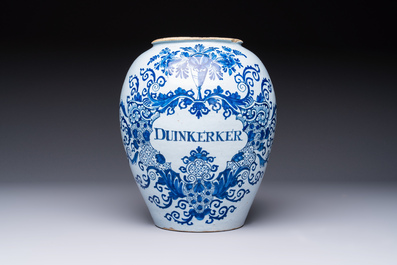 A blue and white Dutch Delft tobacco jar inscribed 'Duinkerker' with brass lid, 18th C.