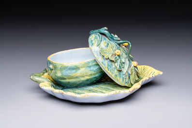 A polychrome Dutch Delft melon-shaped tureen and cover on leaf-shaped stand, 18th C.