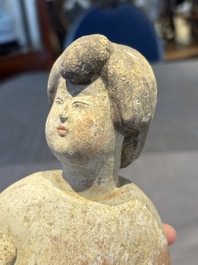 Two Chinese polychrome pottery figures and a female head, Tang