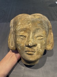 Two Chinese polychrome pottery figures and a female head, Tang