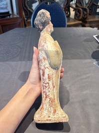 Two Chinese polychrome pottery figures and a female head, Tang