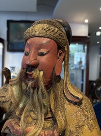 A large Chinese gilt-lacquered and polychrome wooden figure of Guandi, 19th C.