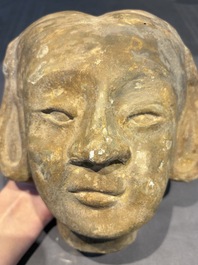 Two Chinese polychrome pottery figures and a female head, Tang