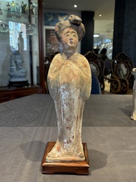Two Chinese polychrome pottery figures and a female head, Tang