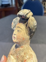 Two Chinese polychrome pottery figures and a female head, Tang